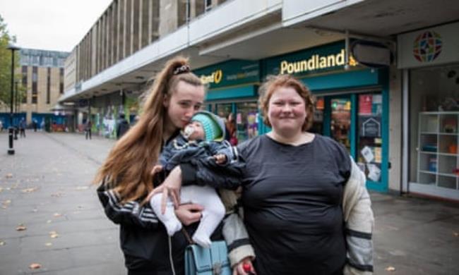 Ellie Barlow (with baby doll) and Nicole Young outside Crompton Place