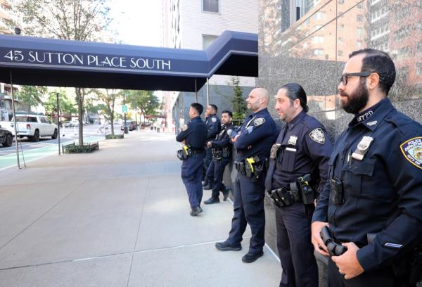 Officers stand in front of the building wher<em></em>e a woman died Sunday. 