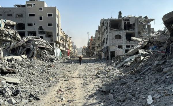 A Palestinian man walks past the rubble after Israeli forces withdrew from the area around Kamal Adwan hospital, amid the o<em></em>ngoing Israel-Hamas conflict, in Jabalia, in the northern Gaza Strip October 26, 2024. REUTERS/Stringer