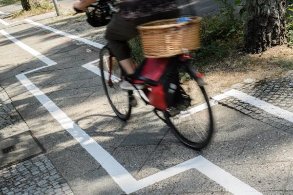 A person on a bike traverses a zig-zag cycle path.