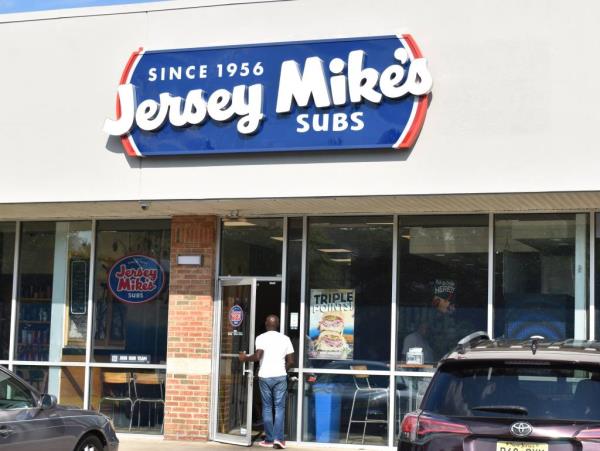 A customer entering a Jersey Mike's sandwich shop in Cherry Hill with a sign on the door a<em></em>bout not using Boar's Head products