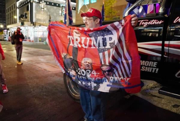 Trump supporters celebrate outside of Trump Tower in New York, NY on November 6, 2024.