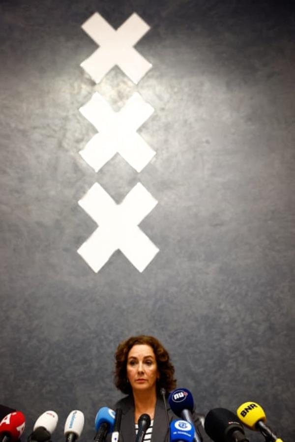 Femke Halsema sits behind a row of press microphones