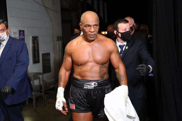 Tyson in his boxing clothes walking, sweaty after a fight 