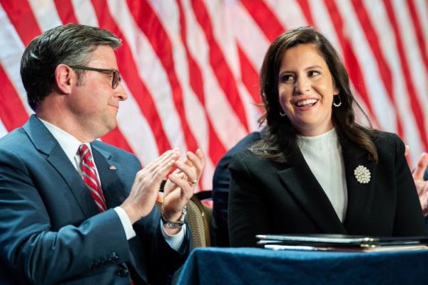 United States Representative Elise Stefanik (Republican of New York) is applauded by Speaker of the US House of Representatives Mike Johnson (Republican of Louisiana) (L) as she is acknowledged by US President-elect Do<em></em>nald Trump alo<em></em>ngside during a meeting with House Republicans at the Hyatt Regency Hotel in Washington, DC on November 13, 2024.