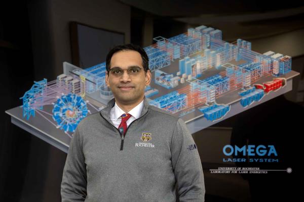 Varchas Gopalaswamy with the Omega Laser Facility illustration in the background.