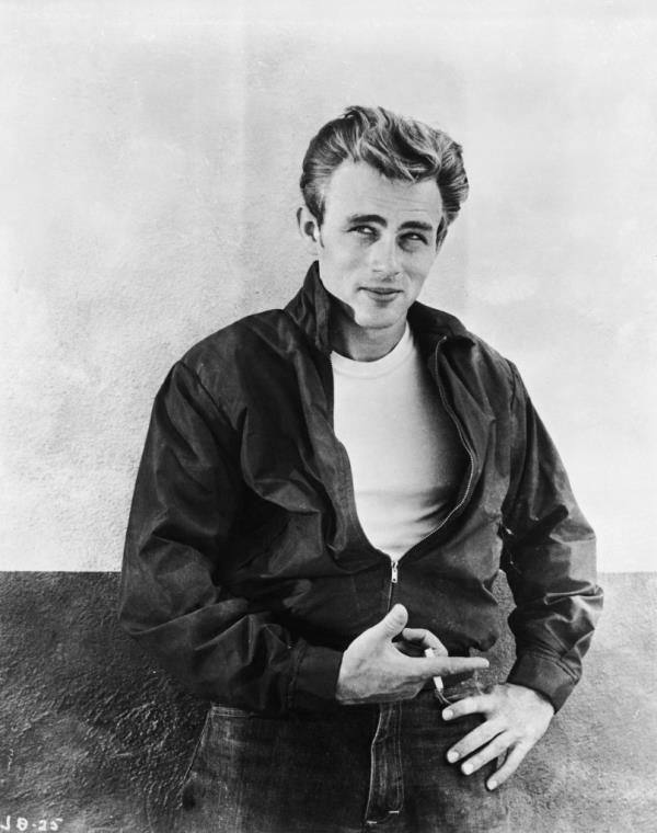 James Dean leaning against a wall on the set of director Nicholas Ray's film, "Rebel Without a Cause," 1955. 