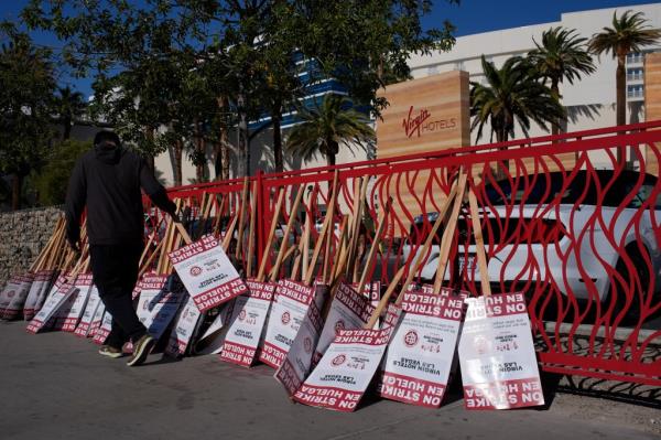 Picket signs lie against a fence in front of the hotel during the hospitality workers' strike. 