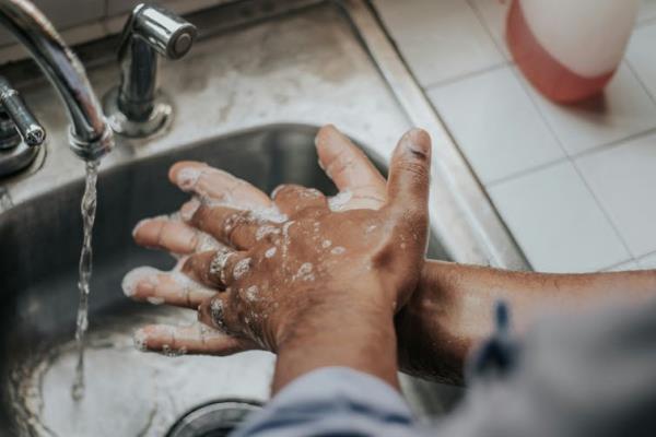 Pair of hands washing with soap and water