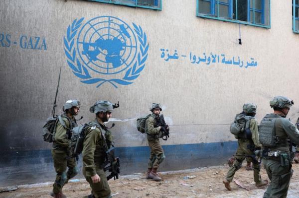 Israeli soldiers operate next to the UNRWA headquarters in the Gaza Strip